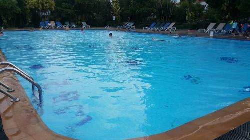 a large swimming pool with people in the water at PATONG TOWER SEA VIEW 3&4 BEDROOMS pta 2026 in Patong Beach