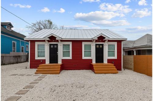 a red tiny house sitting on top of a gravel driveway at Inviting 4BR2.5BA Downtown Home with Ample Space in San Antonio