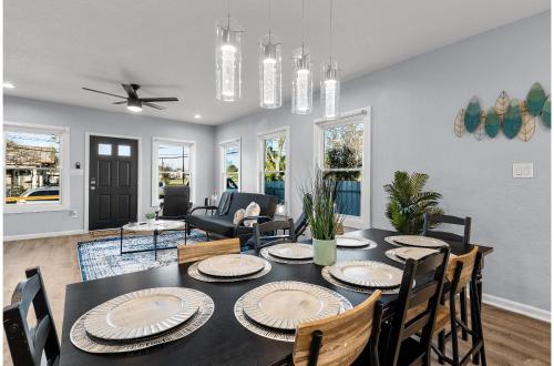 a dining room with a black table and chairs at Inviting 4BR2.5BA Downtown Home with Ample Space in San Antonio