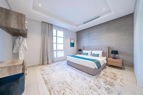 a bedroom with a bed and a large window at Mabaat - Al Yasmeen - 534 - H in Riyadh