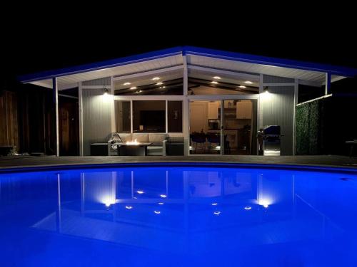 a swimming pool in front of a house at night at Redwood Oasis, Grove and Nook in Felton