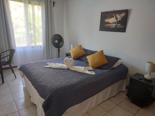 a bedroom with a bed with two towels on it at Casa Arenas in Manuel Antonio