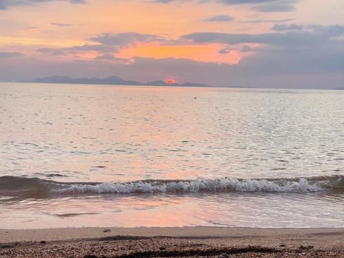 a sunset on the beach with the ocean at Koh Phu Valley in Ko Jum