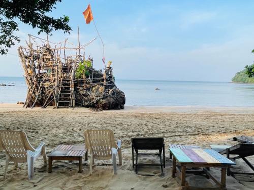 a group of chairs and tables on a beach at Koh Phu Valley in Ko Jum