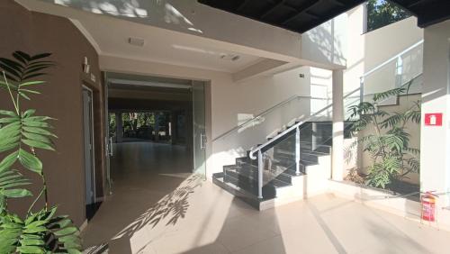a hallway of a house with stairs and plants at Pousada Mandala Botucatu in Botucatu