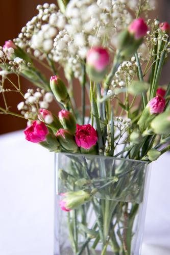 a vase filled with flowers sitting on a table at Whitehouse Country House in Saint Boswells