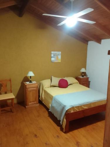 a bedroom with two beds and a ceiling fan at El Elyon Duplex in Santa Rosa de Calamuchita