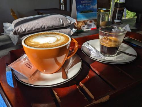 a cup of coffee and a glass of water on a table at Little Pumpkin Cabanas in Tangalle