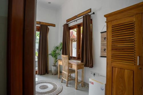 a room with a table and a chair and a window at Villa Madalena 4BR Family Villa w Pool Walk to best Beach & Cafe in Canggu