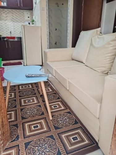 a living room with a white couch and a table at Jackie homes in Mombasa
