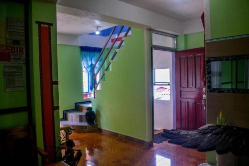 a room with green walls and a red door at BANAUE EVERGREEN HOSTEL AND RESTAURANT in Banaue