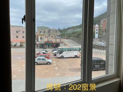 a view from a window of a parking lot at 馬港驛站 Oldharbor Hostel in Nangan