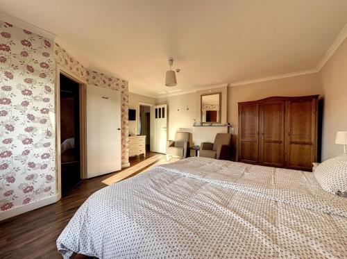 a bedroom with a large bed in a room at La Cour de Grandmenil in Manhay