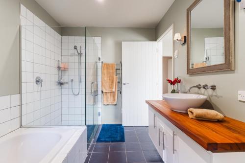 a bathroom with a tub and a sink and a shower at Chinamans Ridge on Chinamans Terrace - Bendigo, Tarras - Central Otago in Tarras