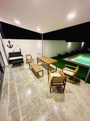 a room with a table and chairs and a pool at The VILLA in Fujairah