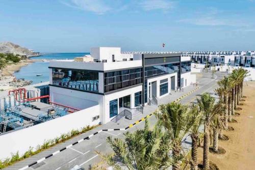 an aerial view of a building next to the beach at The VILLA in Fujairah