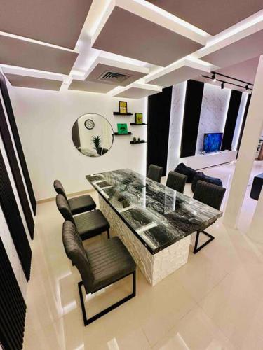 a living room with a dining table and chairs at The VILLA in Fujairah