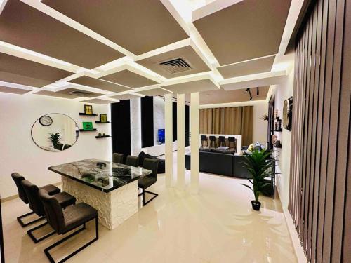 a living room with a table and chairs at The VILLA in Fujairah