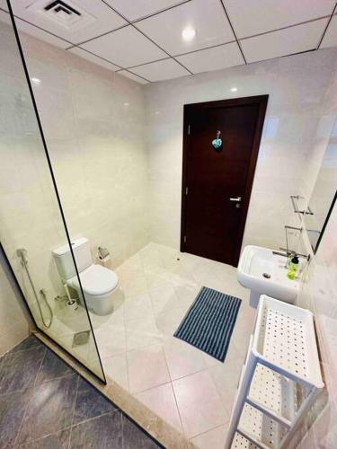 a bathroom with a toilet and a sink at The VILLA in Fujairah