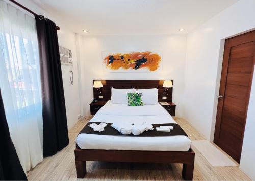 a bedroom with a bed with towels on it at Funtasea Hotel and Beach Resort in Iba
