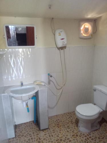 a bathroom with a toilet and a sink at Friendship Guest House in Don Det