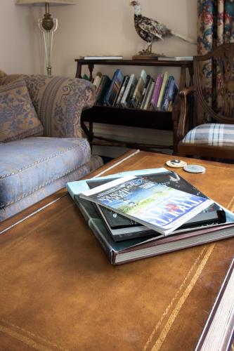 a book on a coffee table in a living room at Whitehouse Country House in Saint Boswells