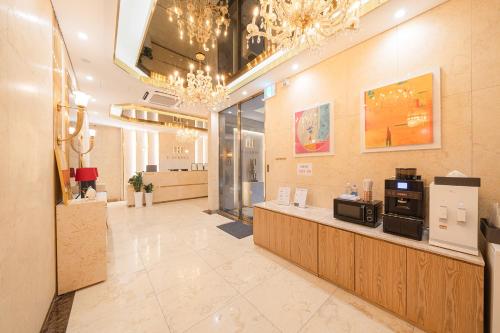 a lobby of a salon with a coffee shop at H-AVENUE HOTEL Yeongdeungpo in Seoul