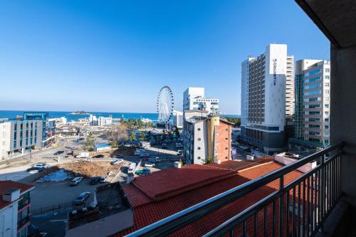 a view of a city from a balcony at Sokcho Good Morning Hotel and Resort in Sokcho