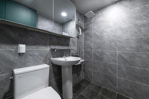 a bathroom with a toilet and a sink at Sokcho Good Morning Hotel and Resort in Sokcho