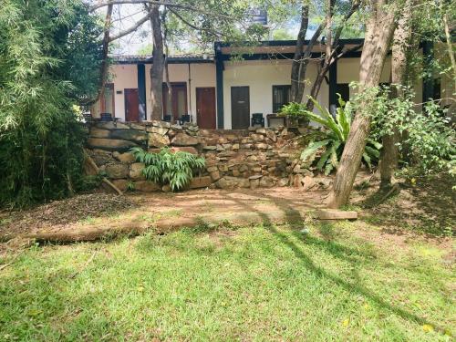 a stone wall in front of a house at Nugasewana Guest in Anuradhapura