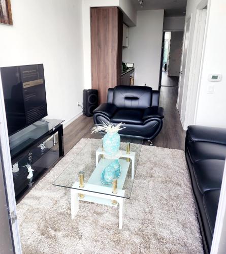 a living room with a couch and a coffee table at Aesthetic & classy apartment unit in Vaughan