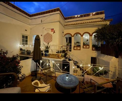 a balcony of a house with a table and chairs at ACORAN FAMILY in Firgas