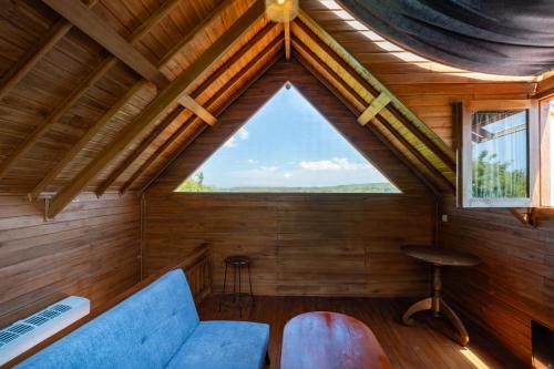 a room with a blue couch and a window at Butterfly Villas Nusa Ceningan in Nusa Lembongan
