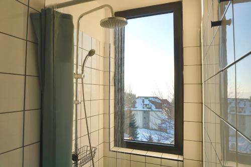 a bathroom with a window with a shower curtain at Montana in Kopaonik