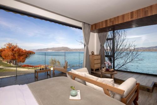 a bedroom with a large view of the water at Dali Beauty Seaview B&B in Dali
