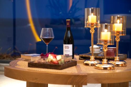 a table with a bottle of wine and a glass at Dali Beauty Seaview B&B in Dali