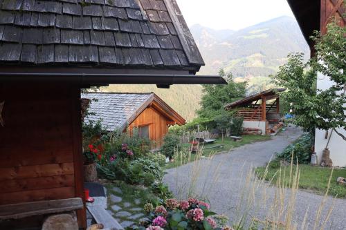a view of a house with a pathway and flowers at Unterplattnerhof in Chiusa