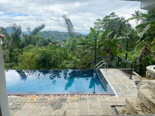 a swimming pool with a view of the mountains at Amandara Hills Kandy in Kandy