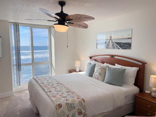 een slaapkamer met een bed en een plafondventilator bij D24 - Cottage on the Sand in Oceanside