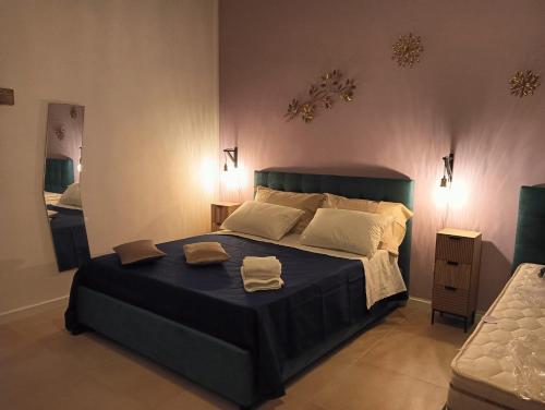 a bedroom with a large bed with two towels on it at PèPè Bed & Breakfast in Naples