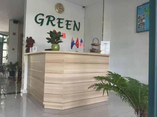 a green sign on the wall of a store at Green Inn Phu Quoc Hotel in Phu Quoc