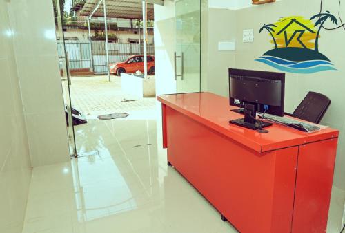 a red desk with a computer on top of it at V K HOLIDAY HOMEs in Malpe