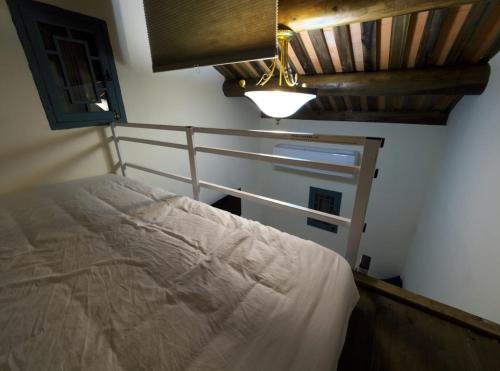 a bedroom with a bed and a wooden ceiling at 老閩宅二館 in Jinhu