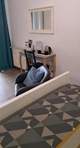 a room with a chair and a table with a table at Il Piccolo B&B in Fiumicino