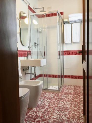 a bathroom with a tub and a sink and a shower at Hotel Villa San Lucchese in Poggibonsi