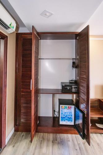 a room with a desk and a closet at Cao Minh Hotel in Lao Cai
