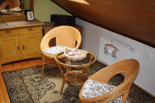 two wicker chairs and a table in a room at Apartment BENCI in Jindrichuv Hradec