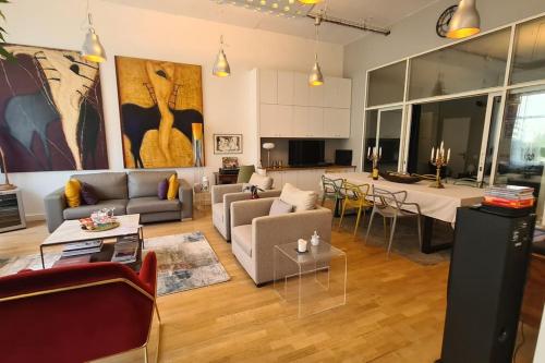 een woonkamer met banken en een eetkamer bij Le loft de Vincennes in Vincennes