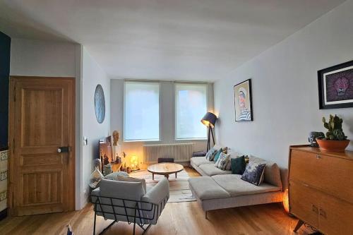 a living room with two couches and a table at Maison de Caractère 8 pers - Jardin - in Lambersart