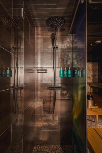 a shower with a glass door in a bathroom at Jänkä Townhouse in Levi